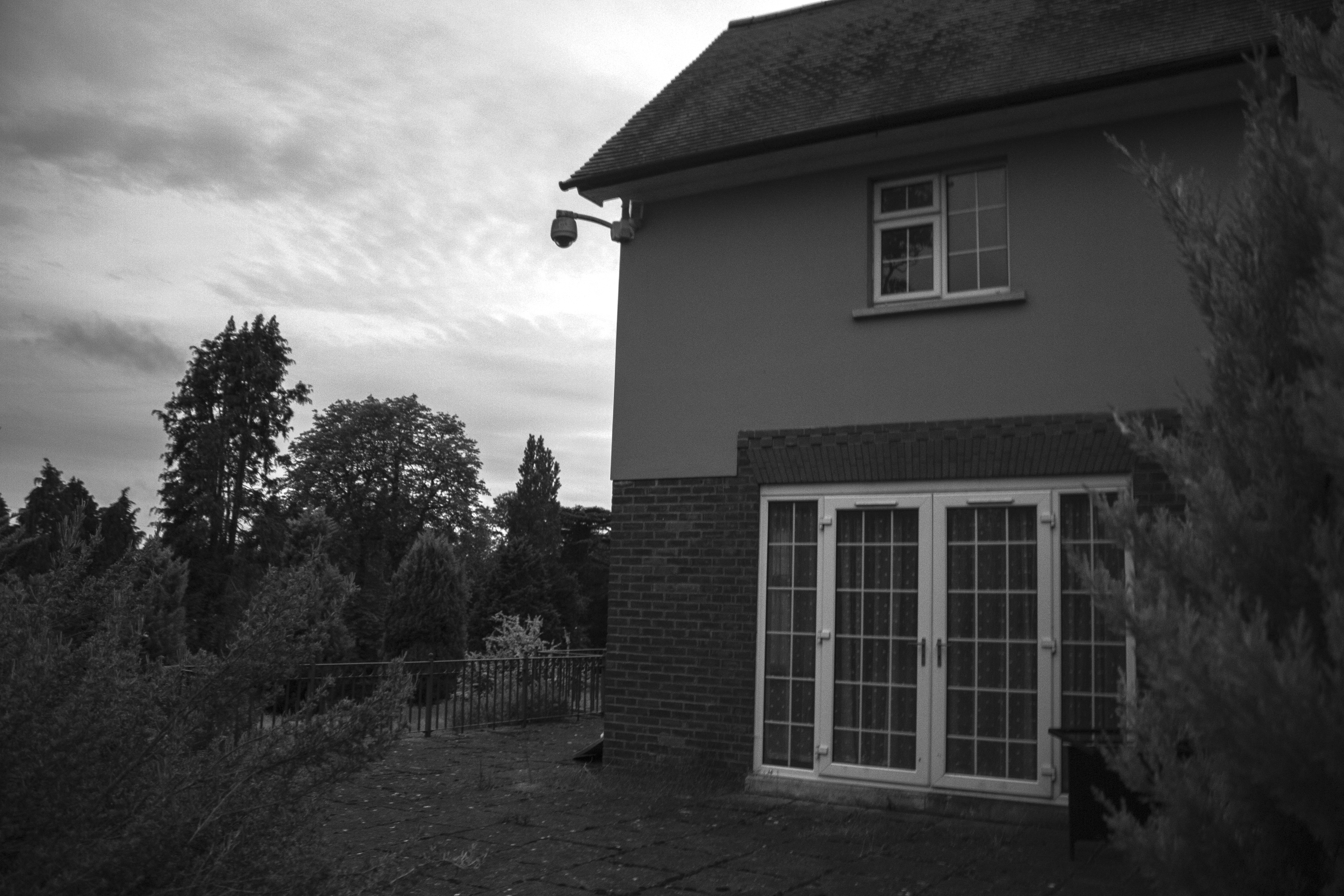 French doors overlooking overgrown lawn