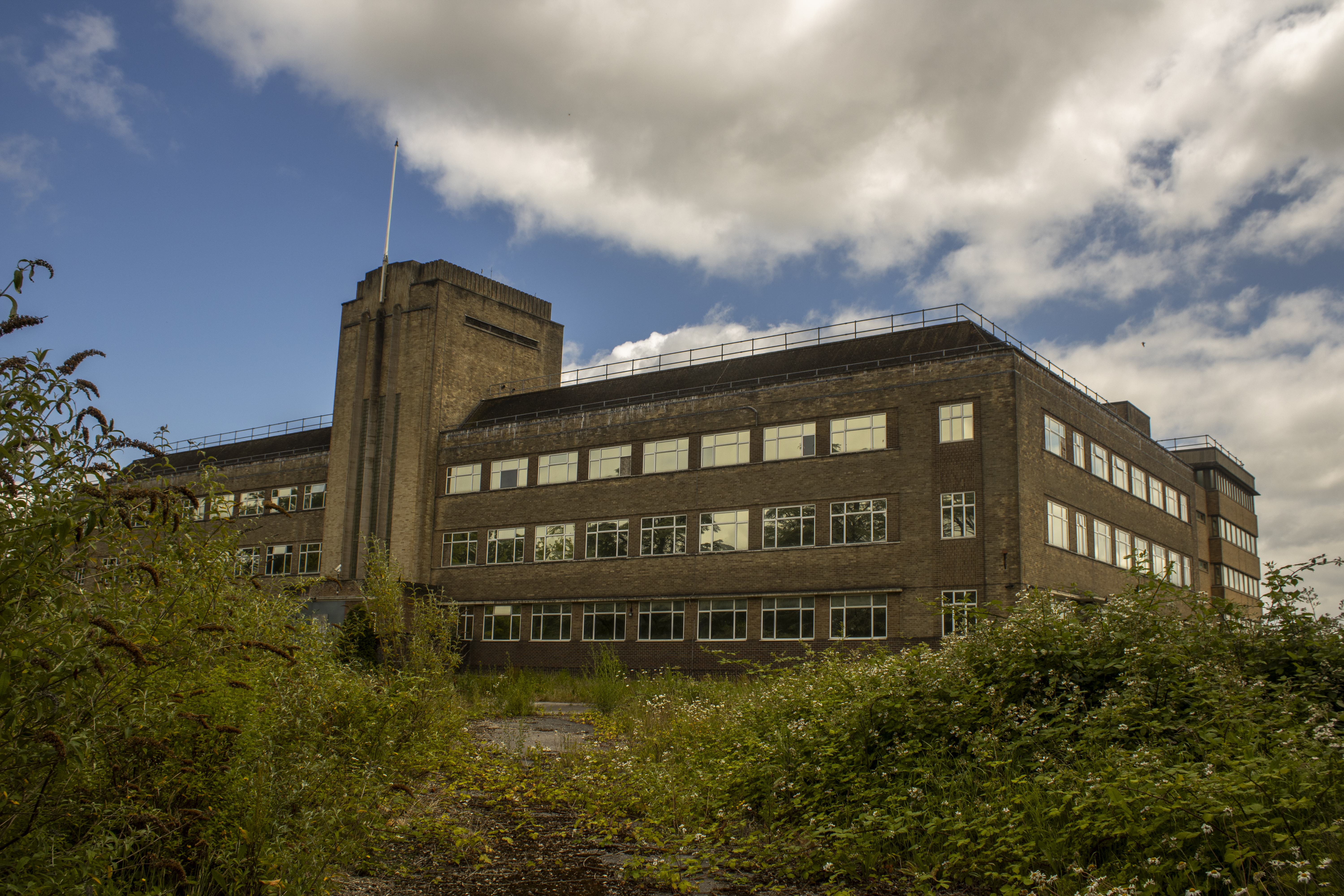 Lab block facade with smashed windows and lazy ivy