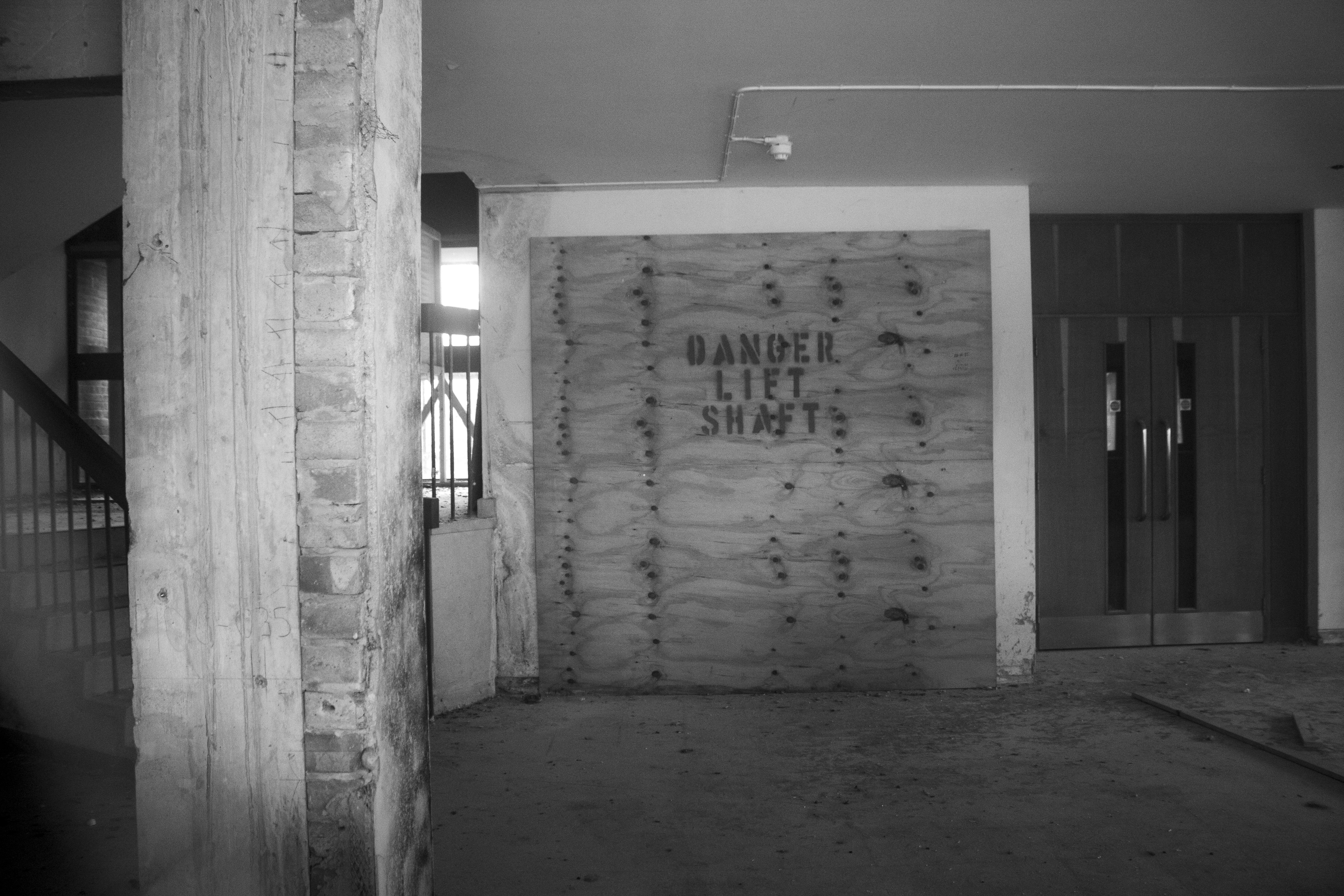 Gutted laboratory space with boarded-up signage