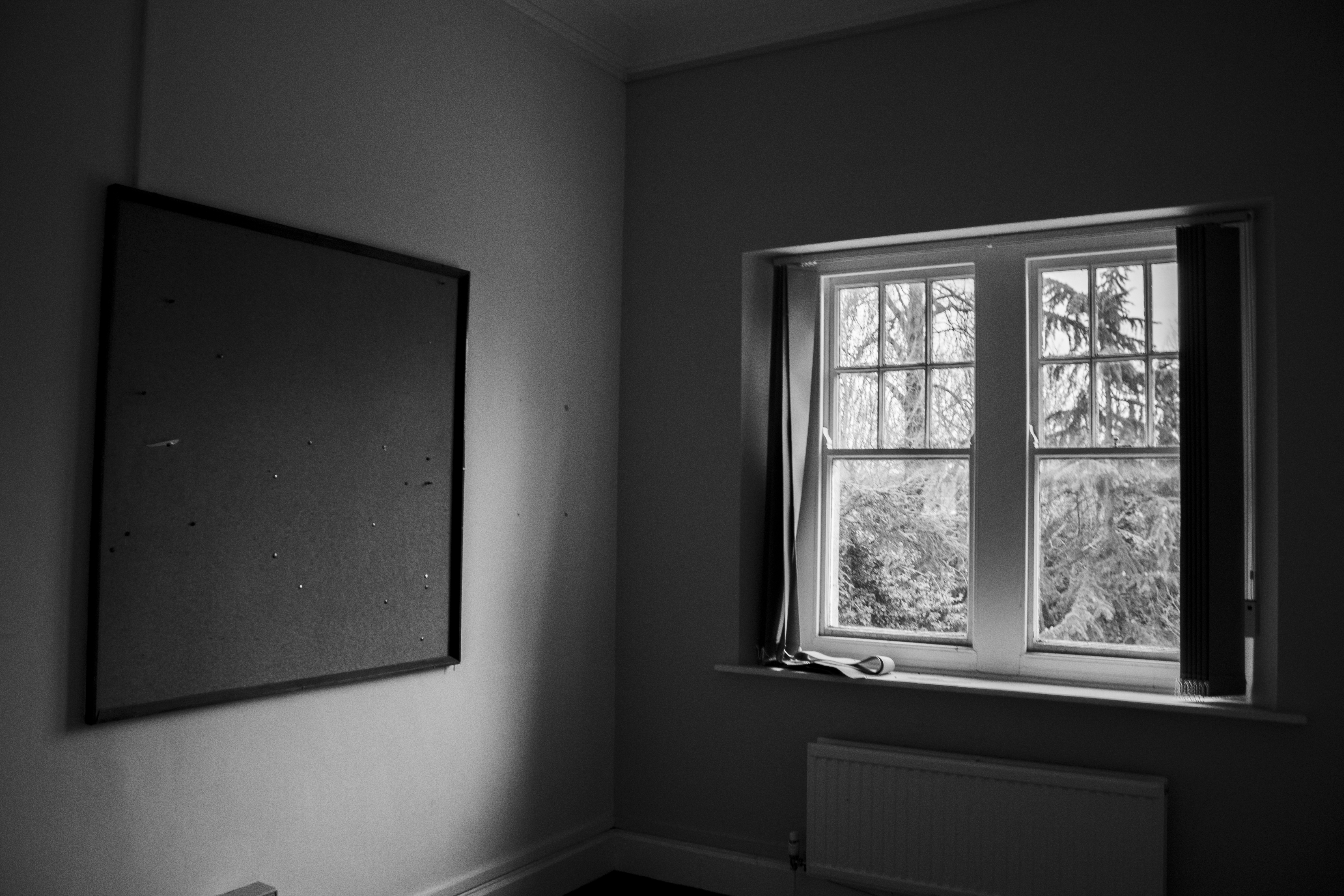 Empty interview room with pinned-up corkboard